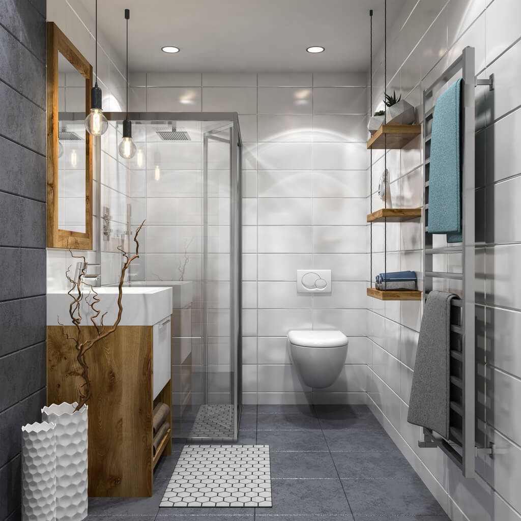 Beautifully lit bathroom featuring a modern bathtub and a vase of fresh flowers on the countertop.