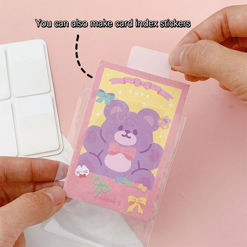 A white person hand holding a sticker with purple bear and a inscription "You can also make card index stickers